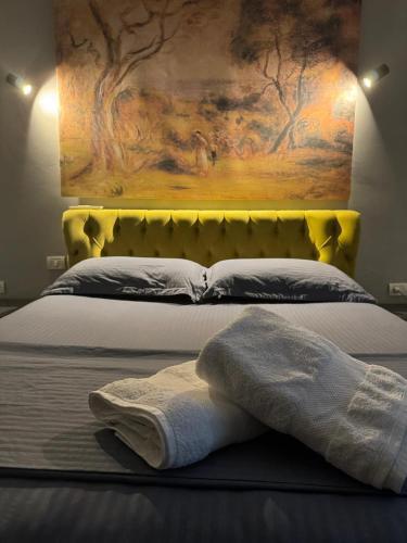 a bedroom with a bed with a yellow headboard at Your house in Tirana in Tirana
