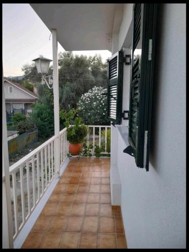 a balcony with a view of a house at Ενοικιαζόμενο Διαμέρισμα in Lygia