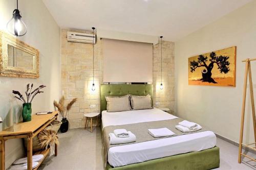 a bedroom with a bed and a desk in it at Villa Maria apartments in Nea Skioni