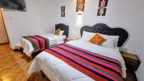 Postel nebo postele na pokoji v ubytování Mallku Wasi - Lodging Hotel Cusco