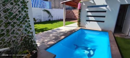 a swimming pool in the backyard of a house at Casa Guacamayas in Tlatenchu