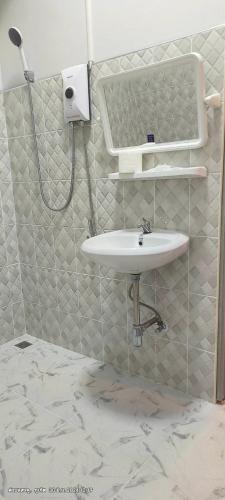a bathroom with a sink and a shower at 449 Airport Phuket in Nai Yang Beach