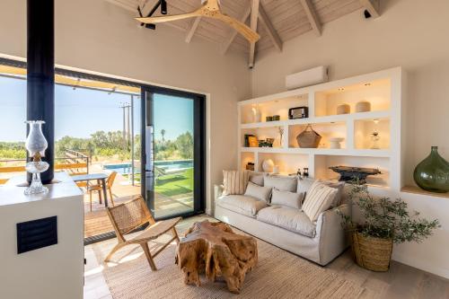 a living room with a couch and a table at Alfarrobeiras NATURE -Agroturismo in Olhão