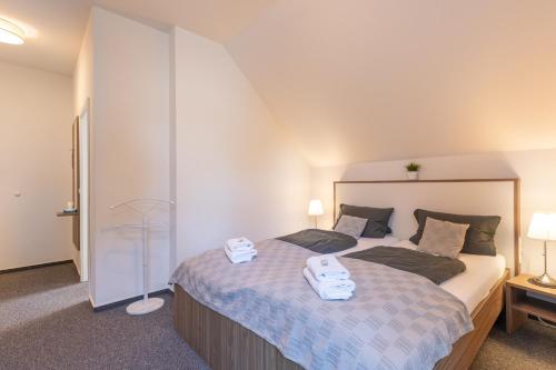 a bedroom with a bed with two towels on it at Gästehaus Wahnbek in Rastede