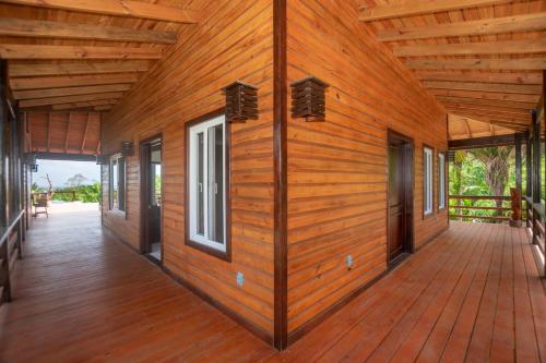 a wooden house with a large deck at Mountain House Palmetto Bay with Private Pool in Roatan