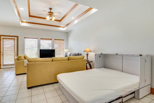a living room with a bed and a couch at Swim, Golf and Unwind Laguna Vista Vacation Home! in Laguna Vista