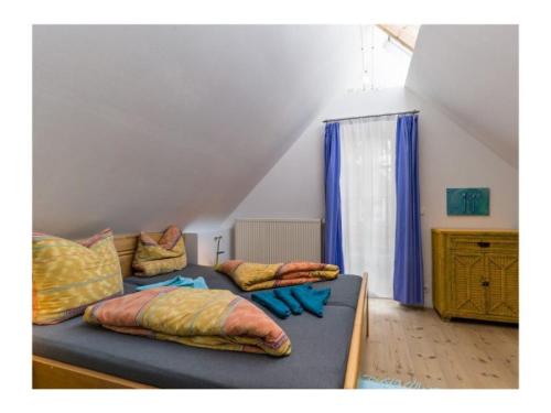 a bed with pillows on it in a room at Ferienhaus Sommerlust in Borkum
