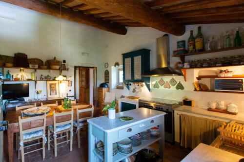 a kitchen with an island in the middle of a room at Vivaia Trendy Rural in Poggibonsi