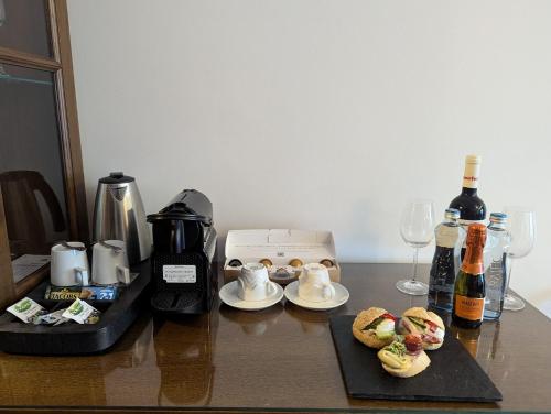 a table with a coffee maker and aasteryasteryasteryasteryasteryasteryasteryastery at Parkhotel Brno in Brno