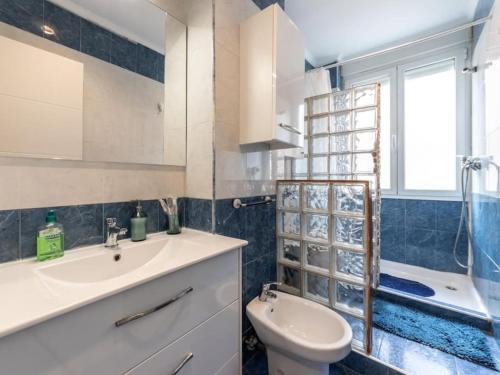 a bathroom with a sink and a toilet and a shower at Gran Bilbao XII by Aston Rentals in Barakaldo