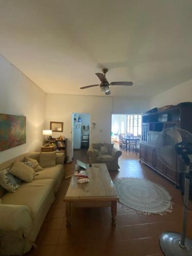 a living room with a couch and a table at Casa centro Urquiza in Gualeguaychú