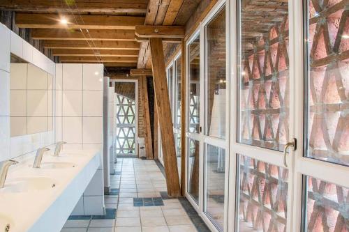 a bathroom with two sinks and a large window at Campingplatz Mauterndorf in Mauterndorf