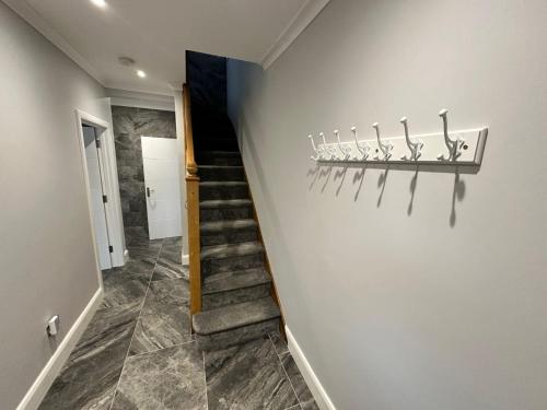 a hallway with a stairway with at Shortwood Stay in Staines upon Thames