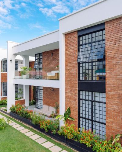 an exterior view of a brick building with windows at Ndani House in Arusha