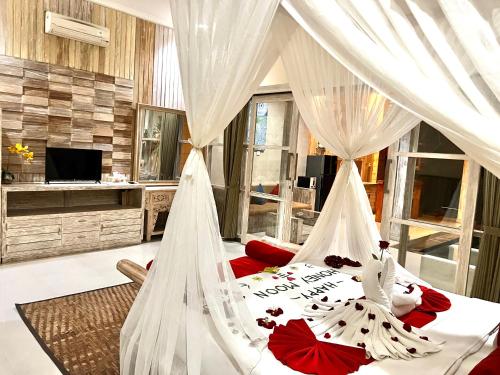 A bed or beds in a room at Sri Permana Suite and Villa Ubud