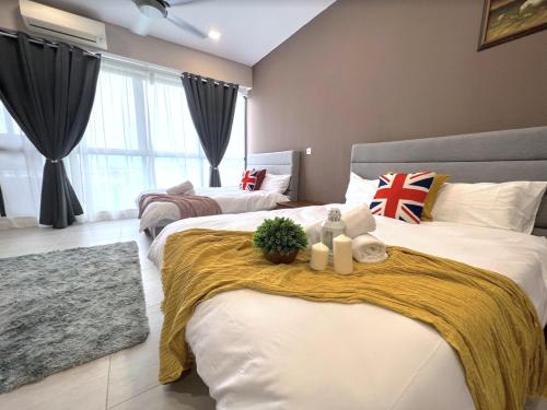a bedroom with two beds with towels and a blanket at BELLSUITE SEPANG NEAR KLIA Airport in Sepang