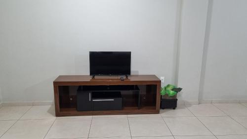a wooden entertainment center with a television on top at Ed Bella Italia in Toledo