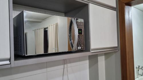 a microwave oven on a shelf in a kitchen at Ed Bella Italia in Toledo