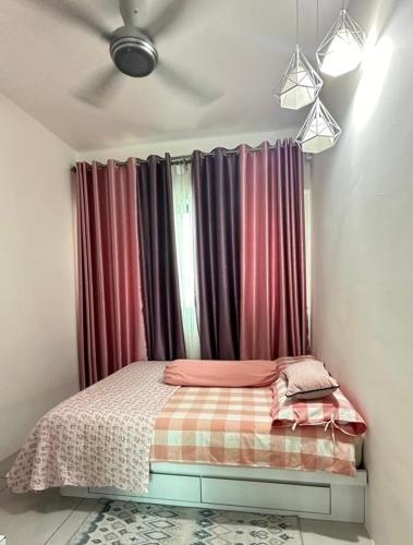 a bed in a room with a window with curtains at Meritus - Perai in Perai