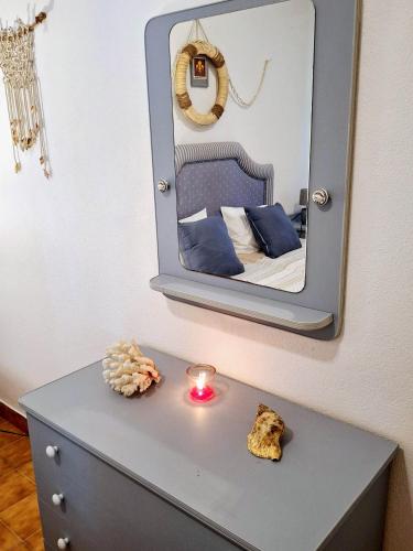 a blue dresser with a mirror on top of it at Casa dos pais in Crato