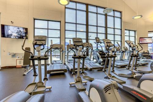 a gym with rows of tread machines in a gym at Indoor Pool Access and Deck Galena Family Getaway! in Galena