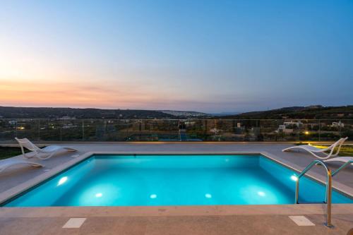 a swimming pool on the roof of a house at Aggel's Infinity View Villa - private pool in Káto Episkopí