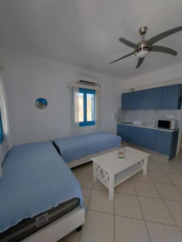 a bedroom with a bed and a table in it at Milithos Apartments 1 in Adamantas