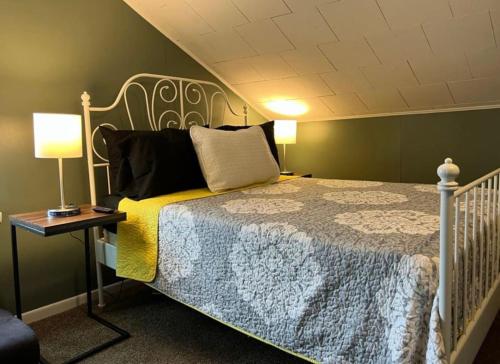 a bedroom with a bed and a table with a lamp at Charming 3 Bedroom Home 6 Beds Sleeps up to 12 in Oswego
