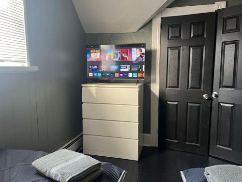 a bedroom with a flat screen tv on a dresser at Beautiful Country Home 7 Beds Sleeps 9 in Johnstown