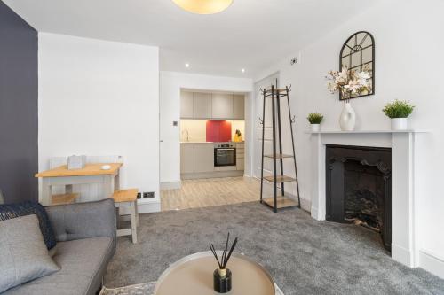 a living room with a couch and a fireplace at WhiskAwayStays - Foregate Street - Apartment 4 in Worcester