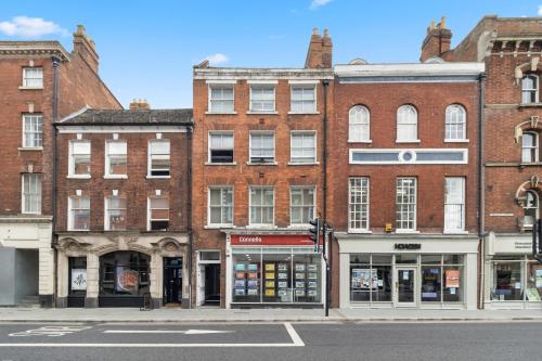 a row of brick buildings on a city street at WhiskAwayStays - Foregate Street - Apartment 4 in Worcester