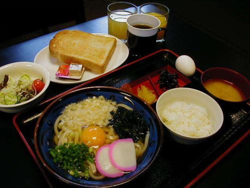una mesa con una bandeja de comida con arroz y huevos en Hotel Takamatsu Hills en Takamatsu