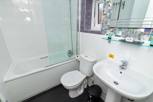 a bathroom with a toilet and a sink and a shower at G Boutique Hotel in Portsmouth