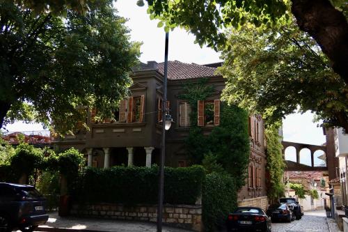 a house with cars parked in front of it at Life Gallery Hotel & Spa in Korçë
