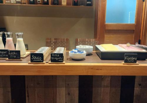 a wooden counter with differentiatesiatesiatesiatesiatesktop at Huenú by DOT Boutique in Villa La Angostura