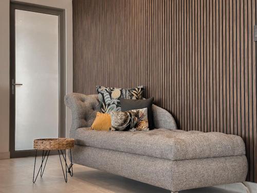 a couch with pillows on it in a living room at Azure Escape in Mossel Bay