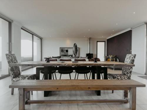 a dining room with a large table and chairs at Azure Escape in Mossel Bay