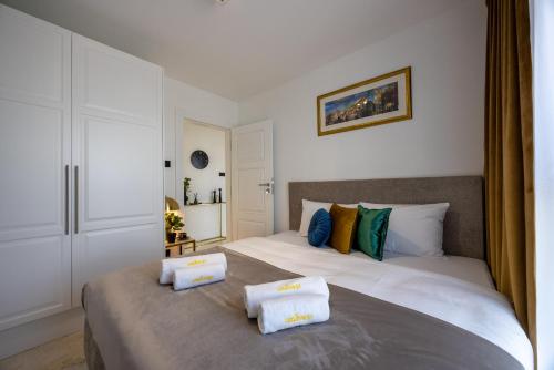 a bedroom with two beds with towels on them at Emihouse Riverside Premium Apartments & Free Parking in Rzeszów