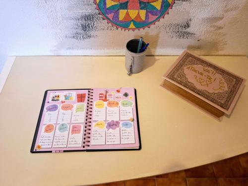 a table with a planner and a pen on it at Casa dos pais in Crato