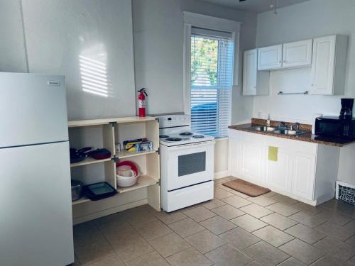 a kitchen with a white stove and a refrigerator at Entire Private STL Apartment - 51A in Carondelet