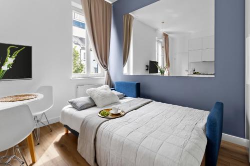 a bedroom with a bed with a plate of food on it at Central Station stylish studio in Warsaw