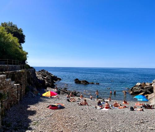 a group of people laying on a beach at B&B Ladidi in Rapallo