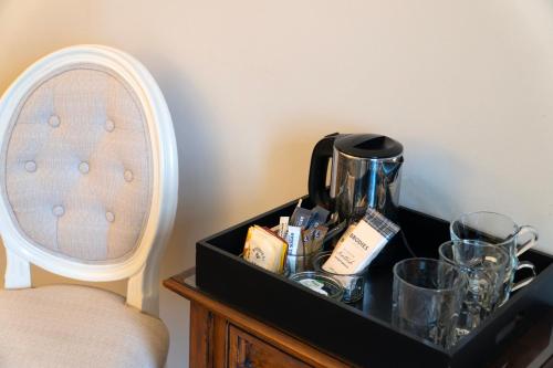 a tray with a coffee maker and glasses on a table at Killean Farmhouse B&B in Inveraray