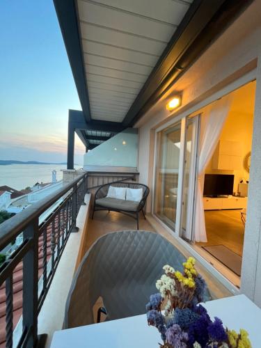 a balcony with a table and a view of the ocean at Top View Residence in Hvar
