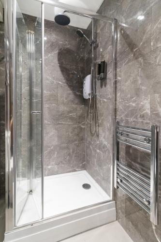 a shower with a glass door in a bathroom at WhiskAwayStays - Foregate Street - Apartment 4 in Worcester