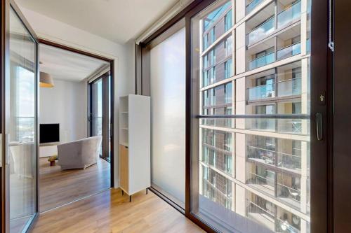 a room with a large window and a living room at 1Bed Flat with city views - 1min walk to tube station in London