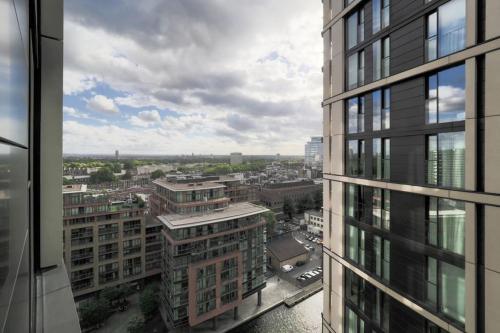 a view of a city from a tall building at 1Bed Flat with city views - 1min walk to tube station in London