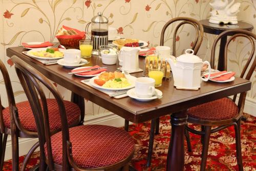 a wooden table with plates of food on it at Meadowside B&B in Bunclody