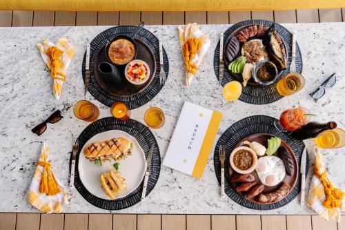 a table with four plates of food on it at Hotel Casa Palopo in Santa Catarina Palopó