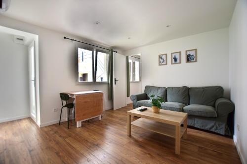 un salon avec un canapé et une table dans l'établissement T2 en RDC climatisé à 50m de la plage et du port, à Mèze